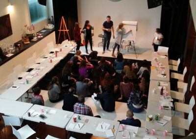 Busy meeting space with multiple tables and participants