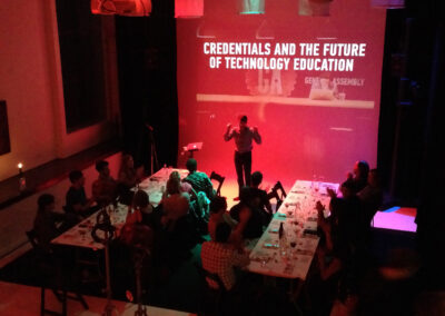 Audience enjoying a presentation while eating at a screening event.