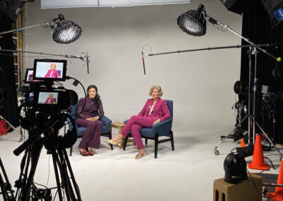 Podcast setup in a modern studio with microphones and lighting.