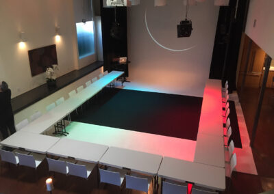 Elegant tables arranged under soft lighting for a screening event.