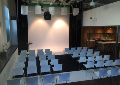 Chairs arranged for a projection screening with ambient lighting.