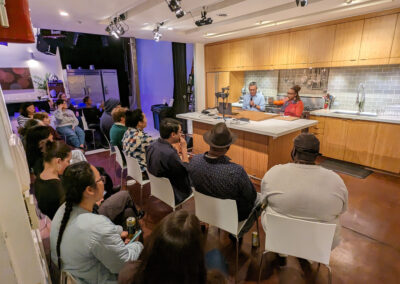 Team having a meeting in a modern kitchen setting.