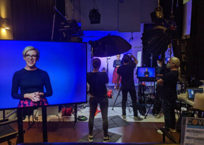 Studio with blue LED colorwash lighting and a camera ready for filming