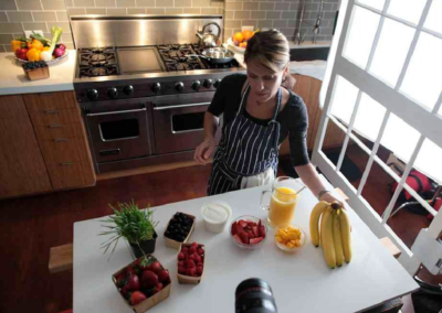 Cooking show episode being filmed in a modern kitchen studio.