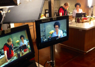 Chef preparing a dish during a cooking episode in a sleek kitchen