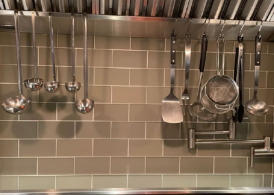 Chef plating a dish in a contemporary kitchen