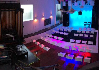 Chairs arranged for a cozy projection screening with bright lighting.